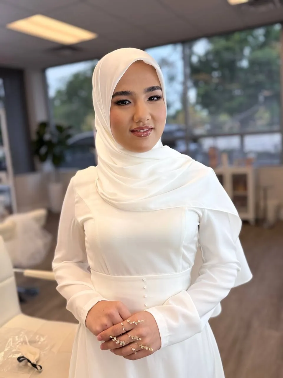 Bride in a white hijab with luminous, natural bridal makeup